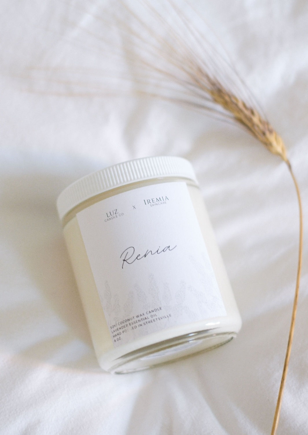 Renia Candle by Luz Candles. It is made with natural soy and coconut waxes and blended together with essential oils that are free of parabens and phthalates. Zero dyes or chemicals are added to the blend. High-quality wooden wicks are used, that produce a beautiful flame and nostalgic fire crackling sound while burning. 
